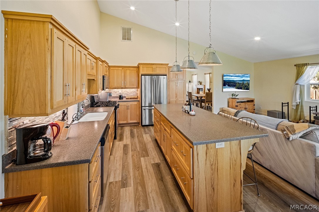 435 Wagon Wheel Road Big Bear City, CA 92314 - Photo 19 of 50 a view of a kitchen with kitchen island stainless steel appliances a large window