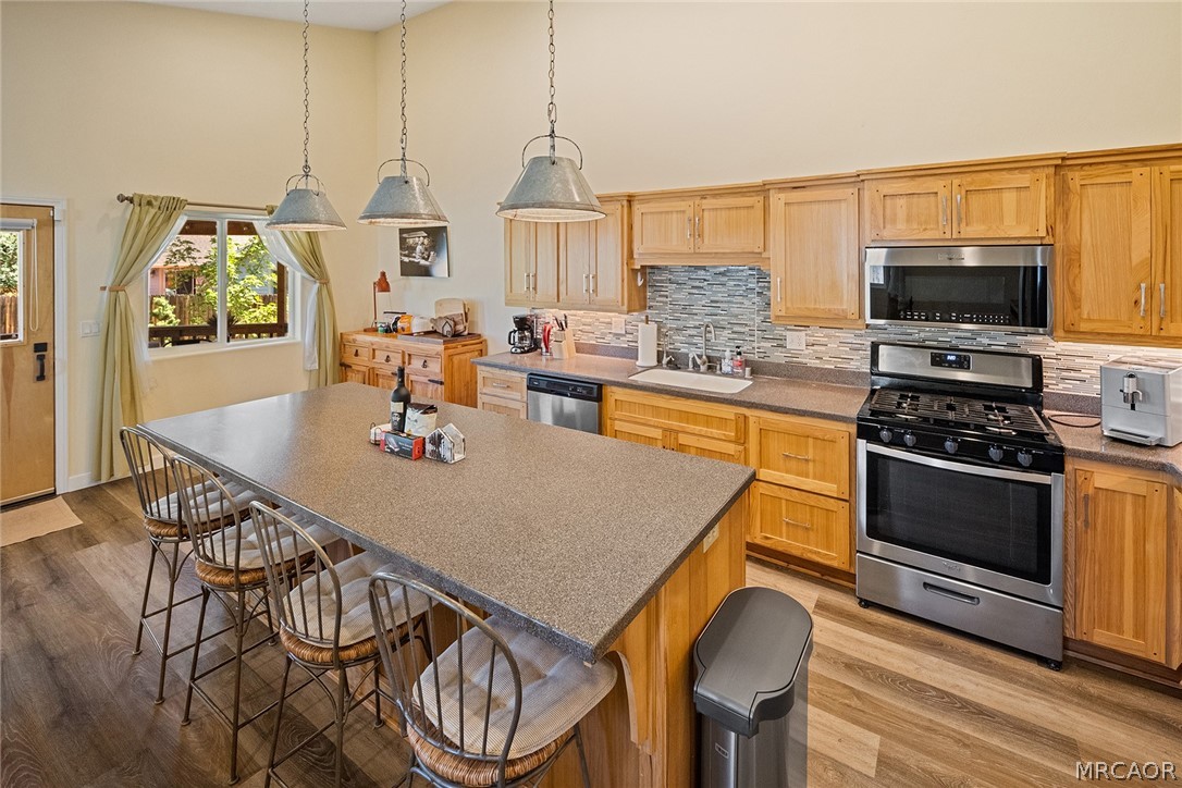 435 Wagon Wheel Road Big Bear City, CA 92314 - Photo 22 of 50 a living room with stainless steel appliances furniture a rug and a kitchen view