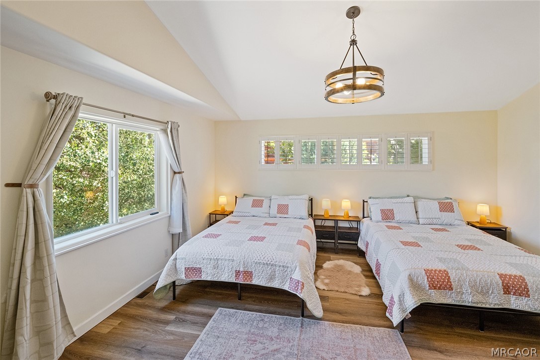 435 Wagon Wheel Road Big Bear City, CA 92314 - Photo 26 of 50 a bedroom with a bed and window