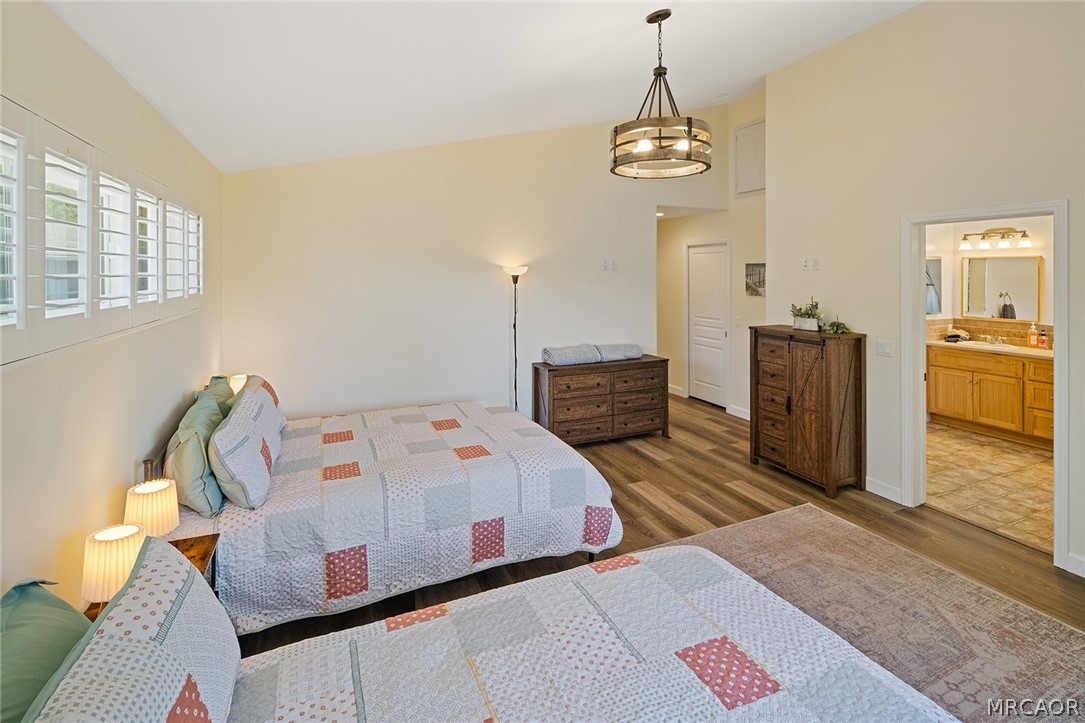 435 Wagon Wheel Road Big Bear City, CA 92314 - Photo 27 of 50 a bedroom with a bed and wooden floor