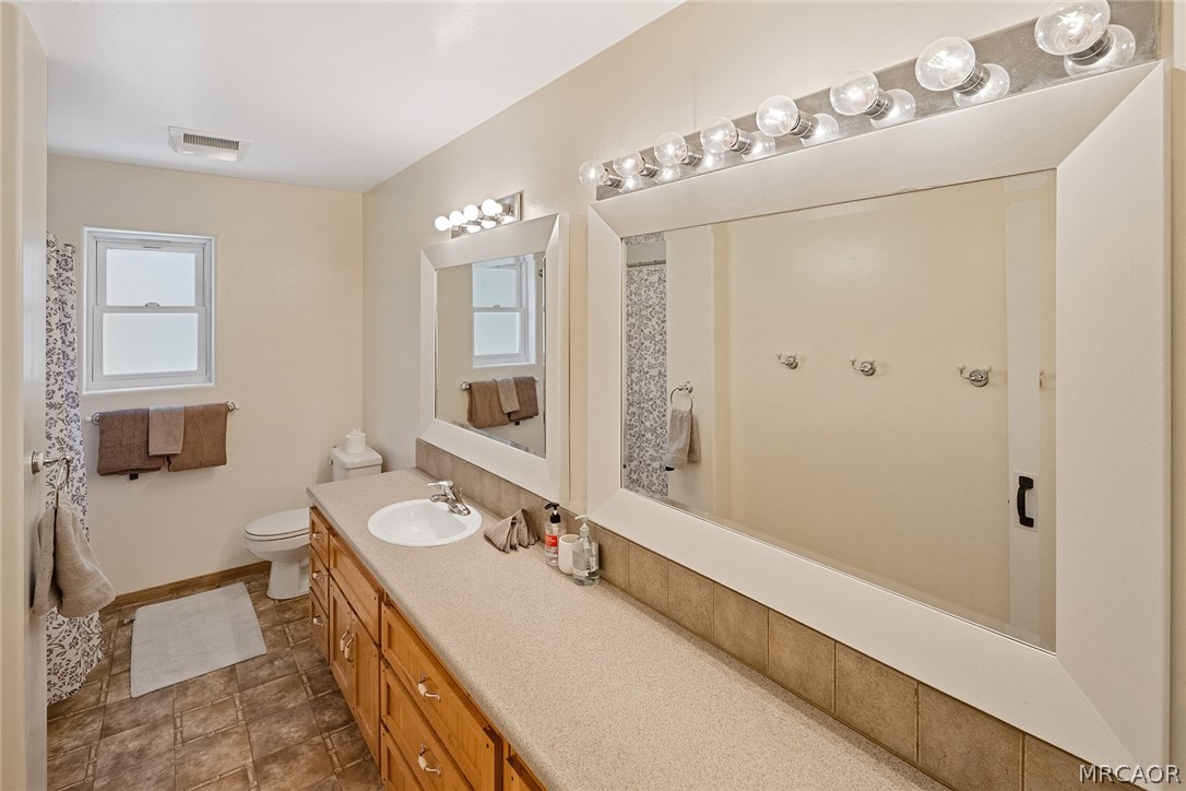435 Wagon Wheel Road Big Bear City, CA 92314 - Photo 34 of 50 a bathroom with a double vanity sink mirror and