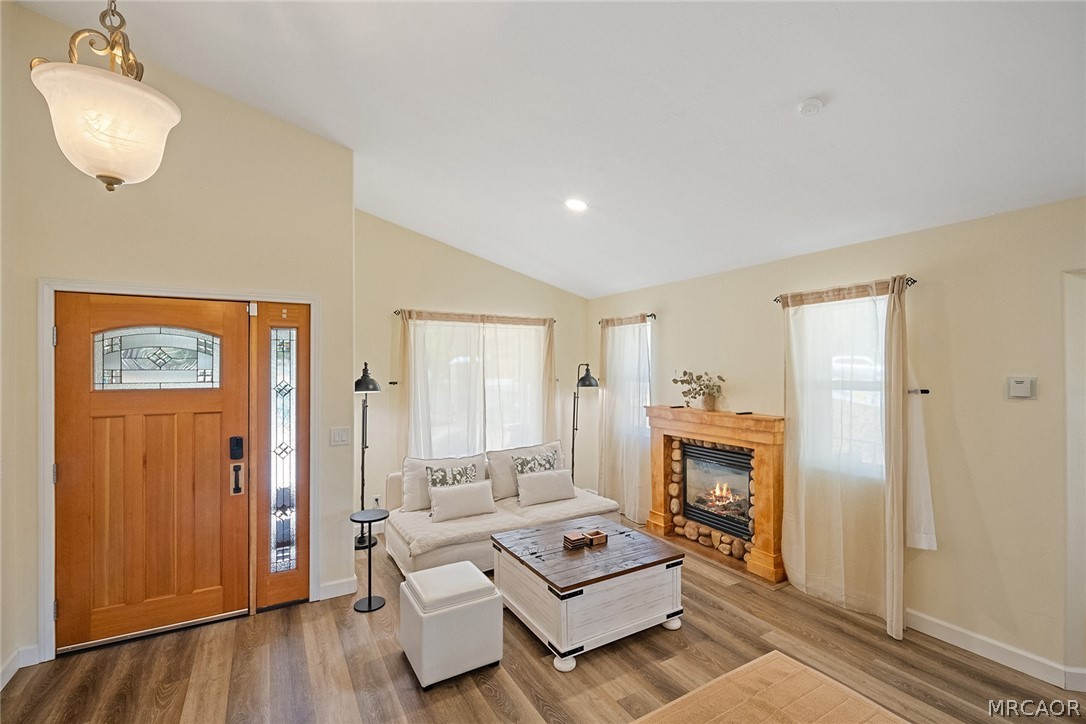 435 Wagon Wheel Road Big Bear City, CA 92314 - Photo 7 of 50 a living room with furniture a fireplace and a wooden floor