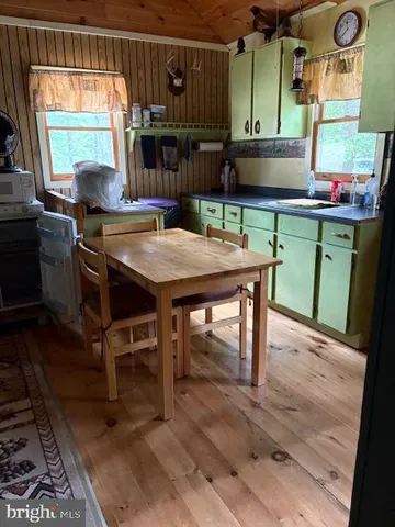 a room with a table chairs and a window