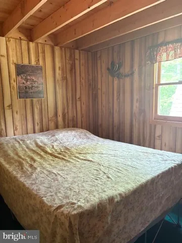 a bed sitting in a bedroom next to a window