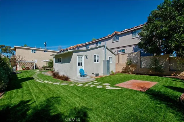 a view of a house with backyard porch and sitting area