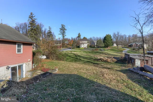 a view of a house with a yard and sitting area