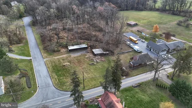 a aerial view of a house with a yard and lake view