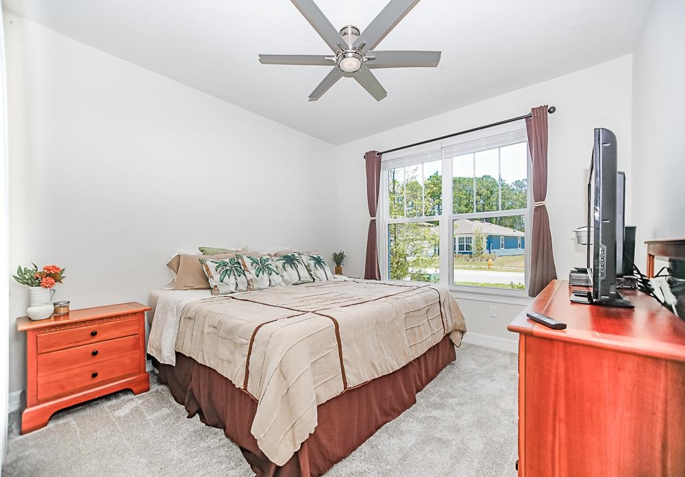 233 Red Barn Road St. Augustine, FL 32092 - Photo 17 of 40 a bedroom with a bed and a flat tv screen on dresser