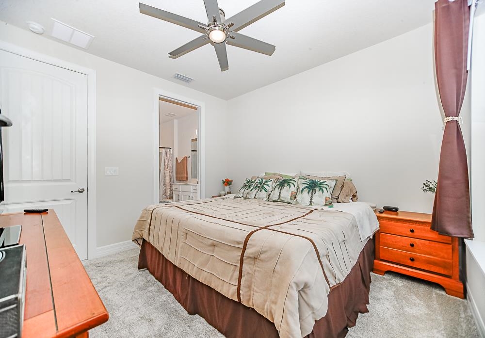 233 Red Barn Road St. Augustine, FL 32092 - Photo 18 of 40 a bedroom with a bed and wooden floor