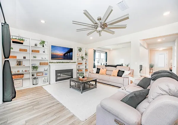 a living room with furniture a fireplace and a flat screen tv