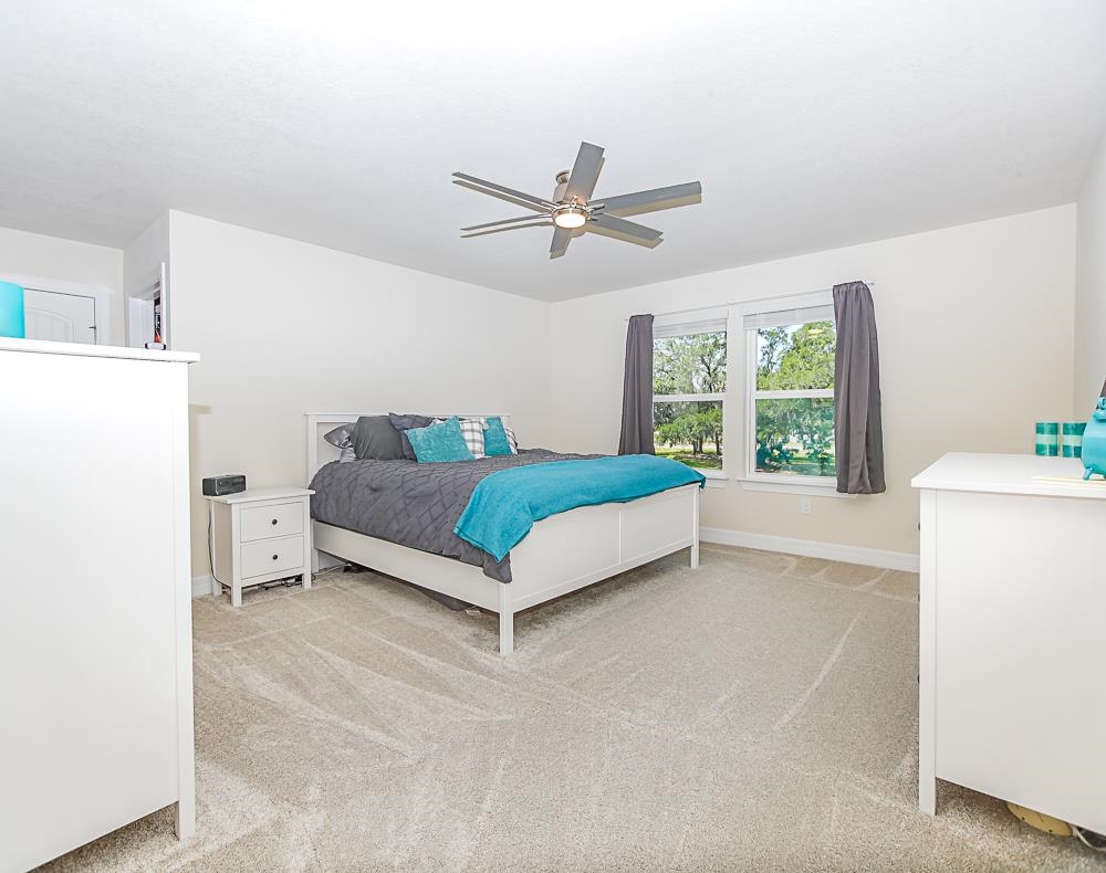 233 Red Barn Road St. Augustine, FL 32092 - Photo 4 of 40 a living room with a bed furniture and a large window