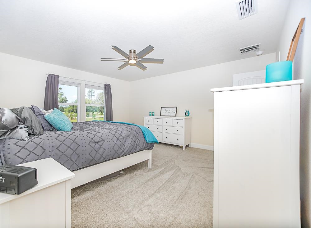 233 Red Barn Road St. Augustine, FL 32092 - Photo 5 of 40 a bedroom with a bed a dresser and a window