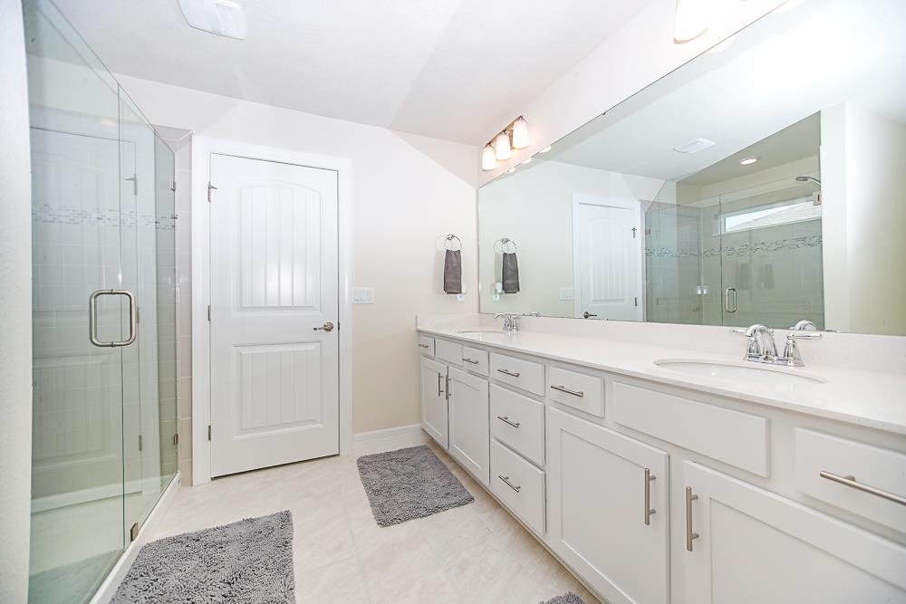 233 Red Barn Road St. Augustine, FL 32092 - Photo 6 of 40 a spacious bathroom with double sink and a mirror