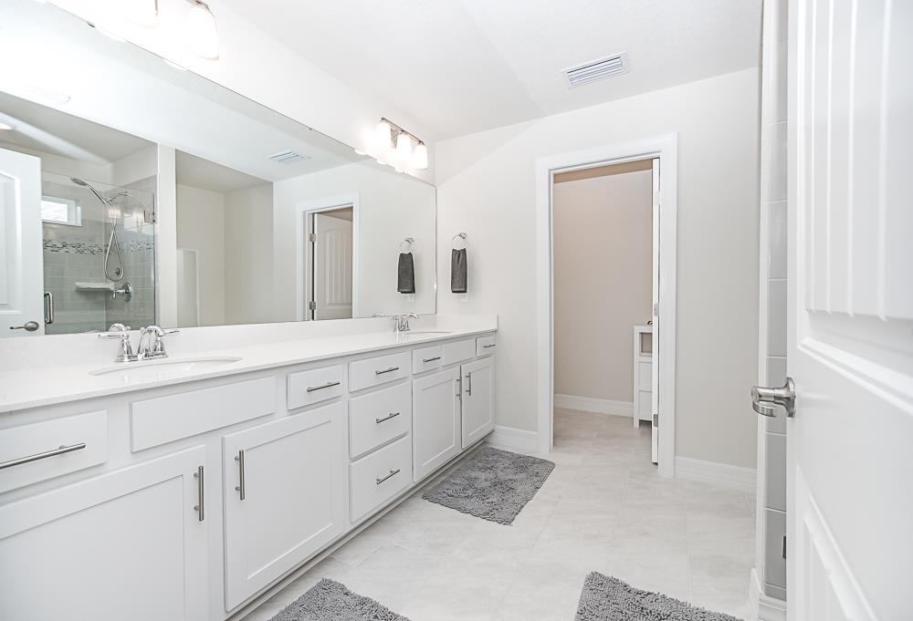 233 Red Barn Road St. Augustine, FL 32092 - Photo 8 of 40 a spacious bathroom with double sink and a mirror