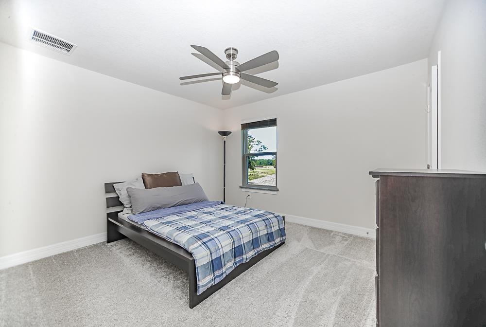 233 Red Barn Road St. Augustine, FL 32092 - Photo 9 of 40 a bedroom with a bed and window