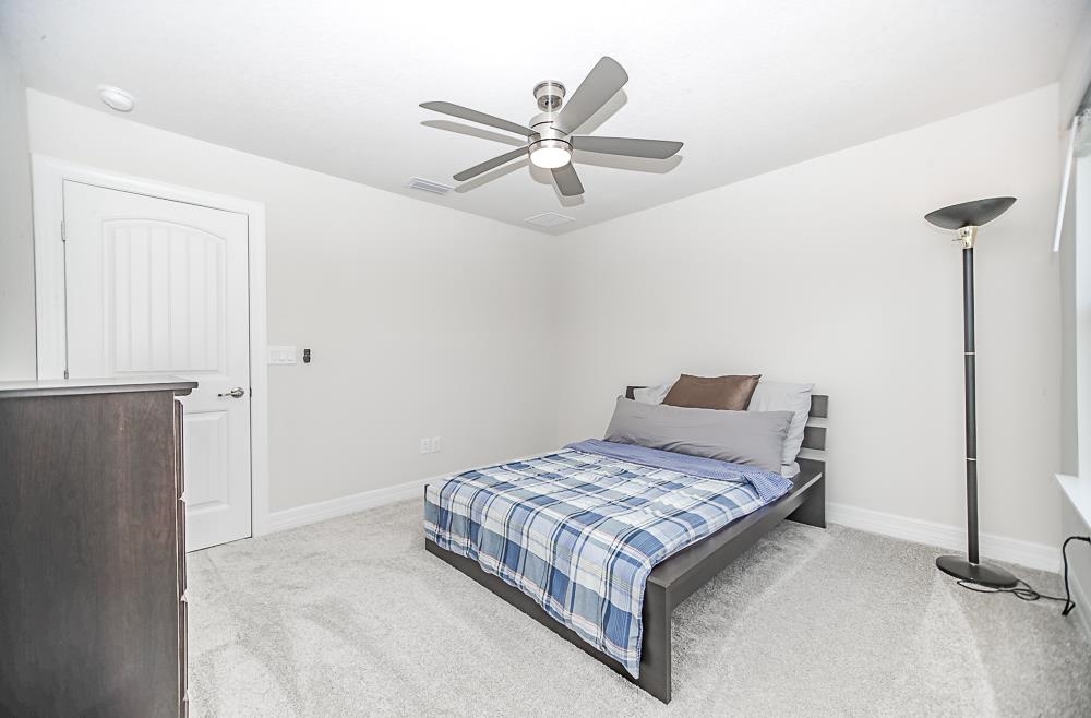 233 Red Barn Road St. Augustine, FL 32092 - Photo 10 of 40 a living room with a bed and ceiling fan