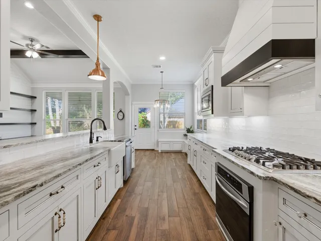 a kitchen with granite countertop a stove and a sink