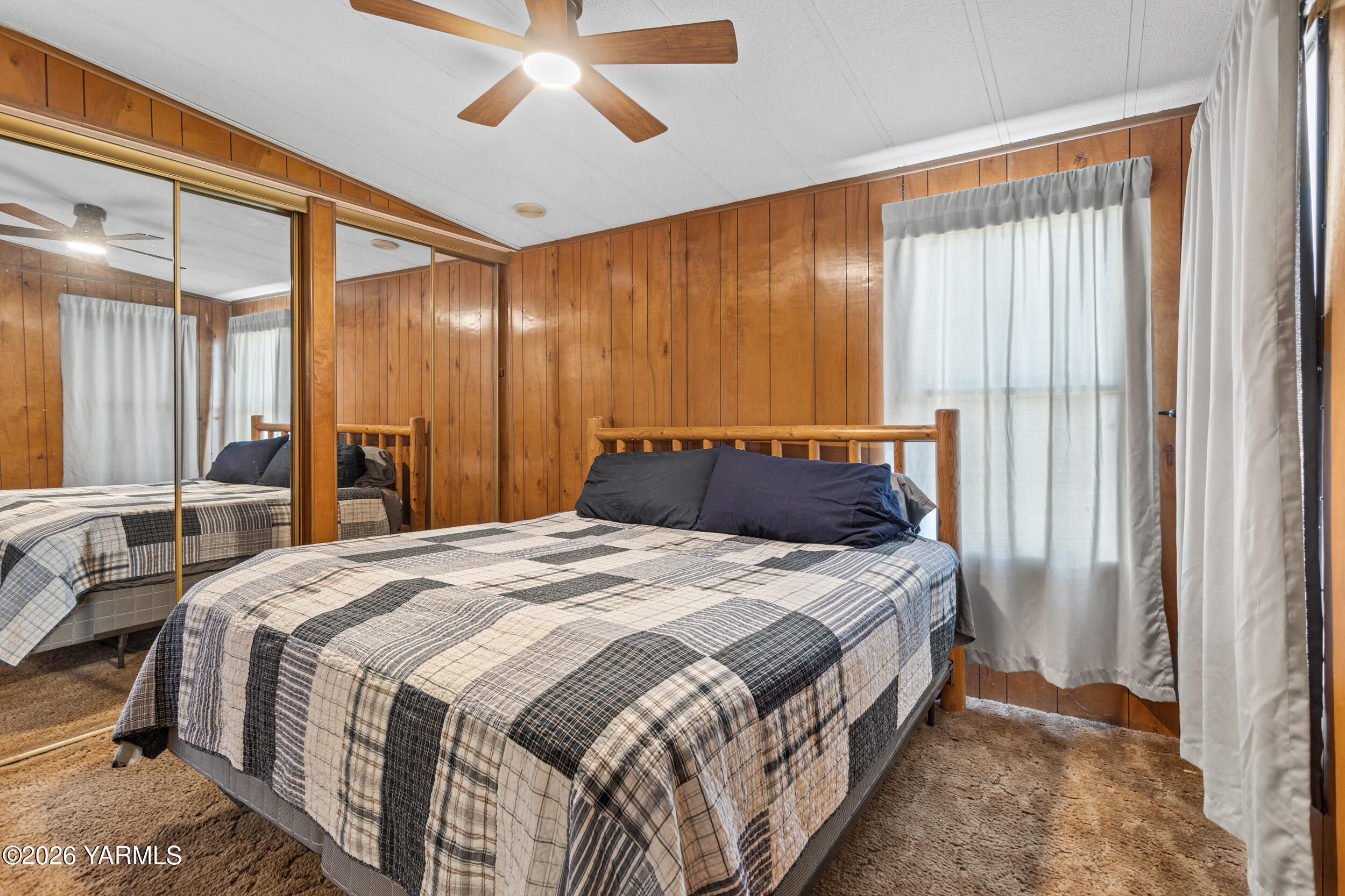 142 Foster Lane Selah, WA 98942 - Photo 13 of 21 a bed sitting in a spacious bedroom next to a window