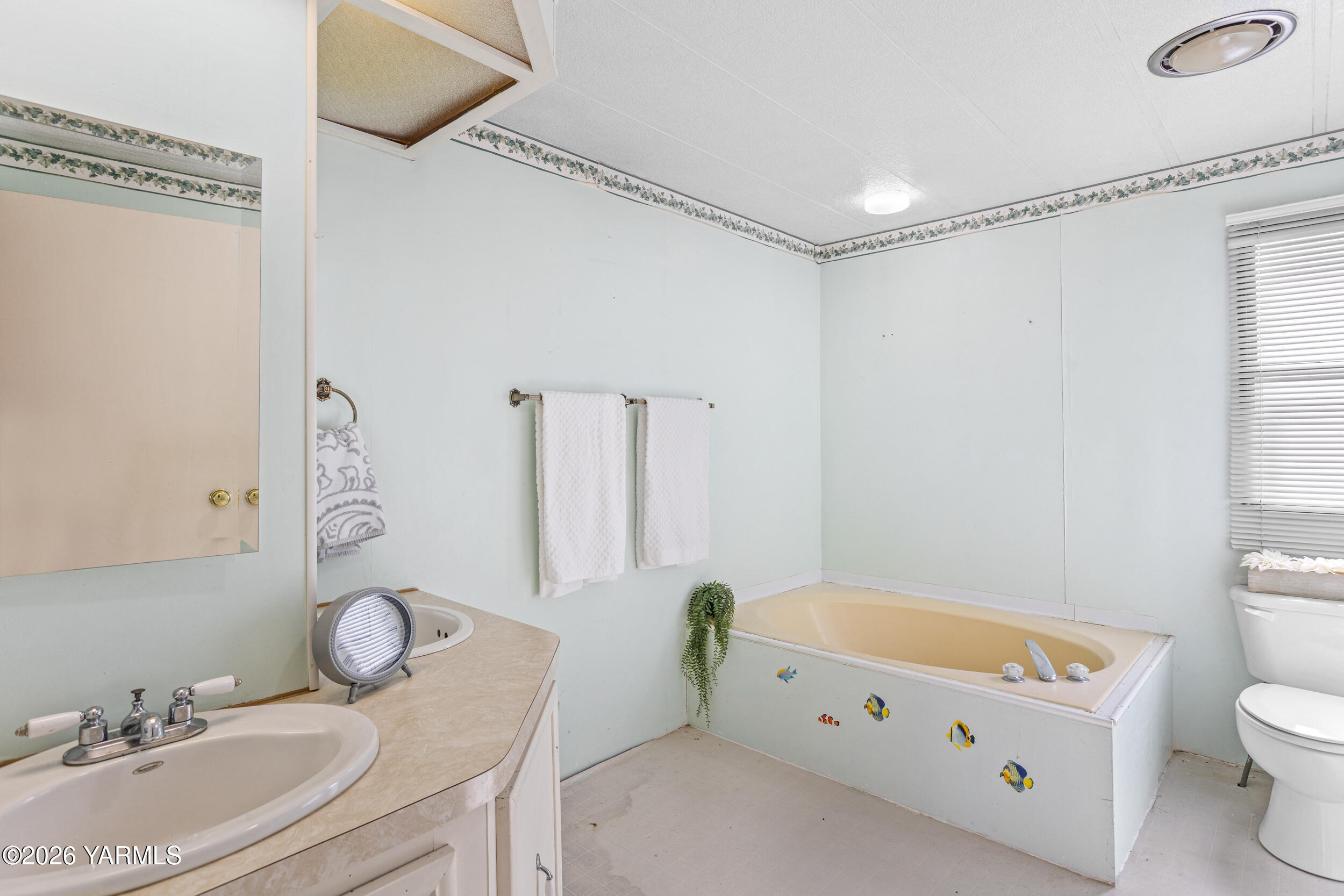 142 Foster Lane Selah, WA 98942 - Photo 18 of 21 a bathroom with a granite countertop sink a toilet a mirror and shower