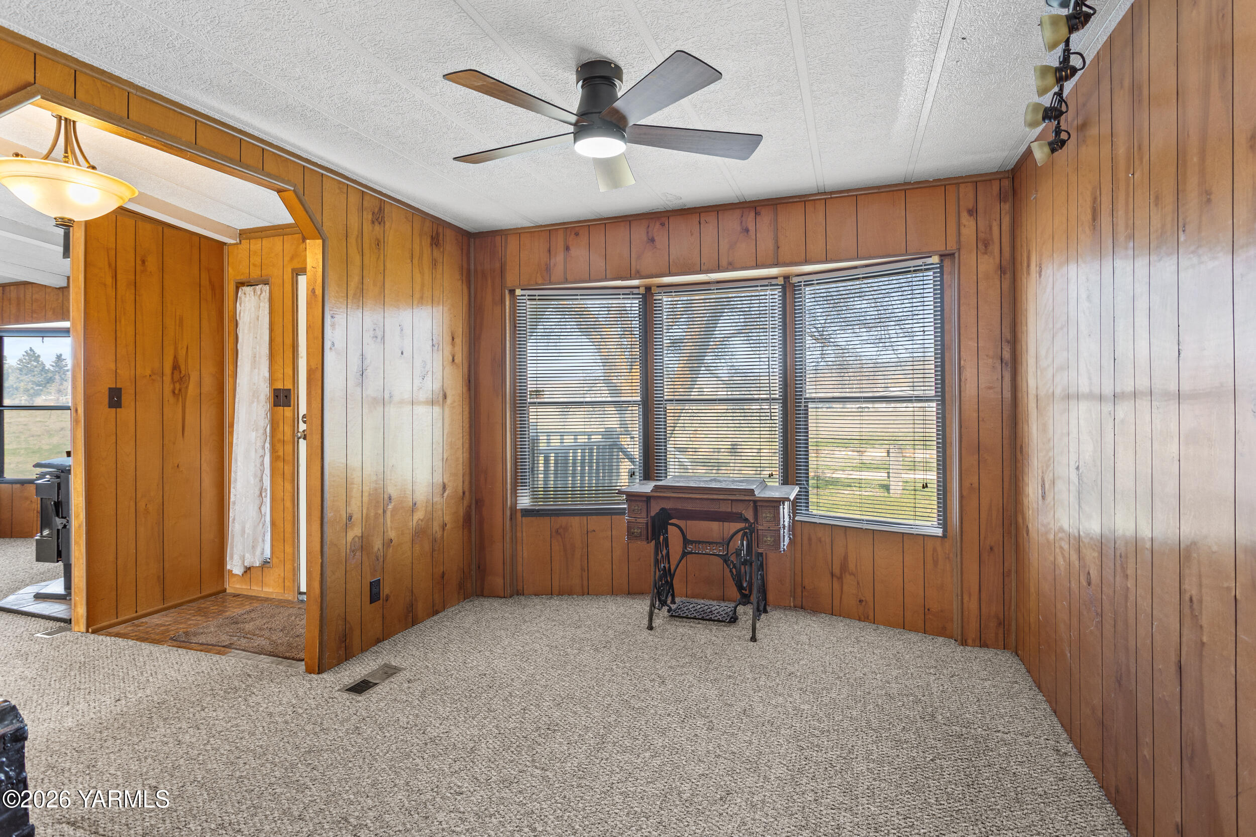 142 Foster Lane Selah, WA 98942 - Photo 5 of 21 an empty room with chandelier fan and windows