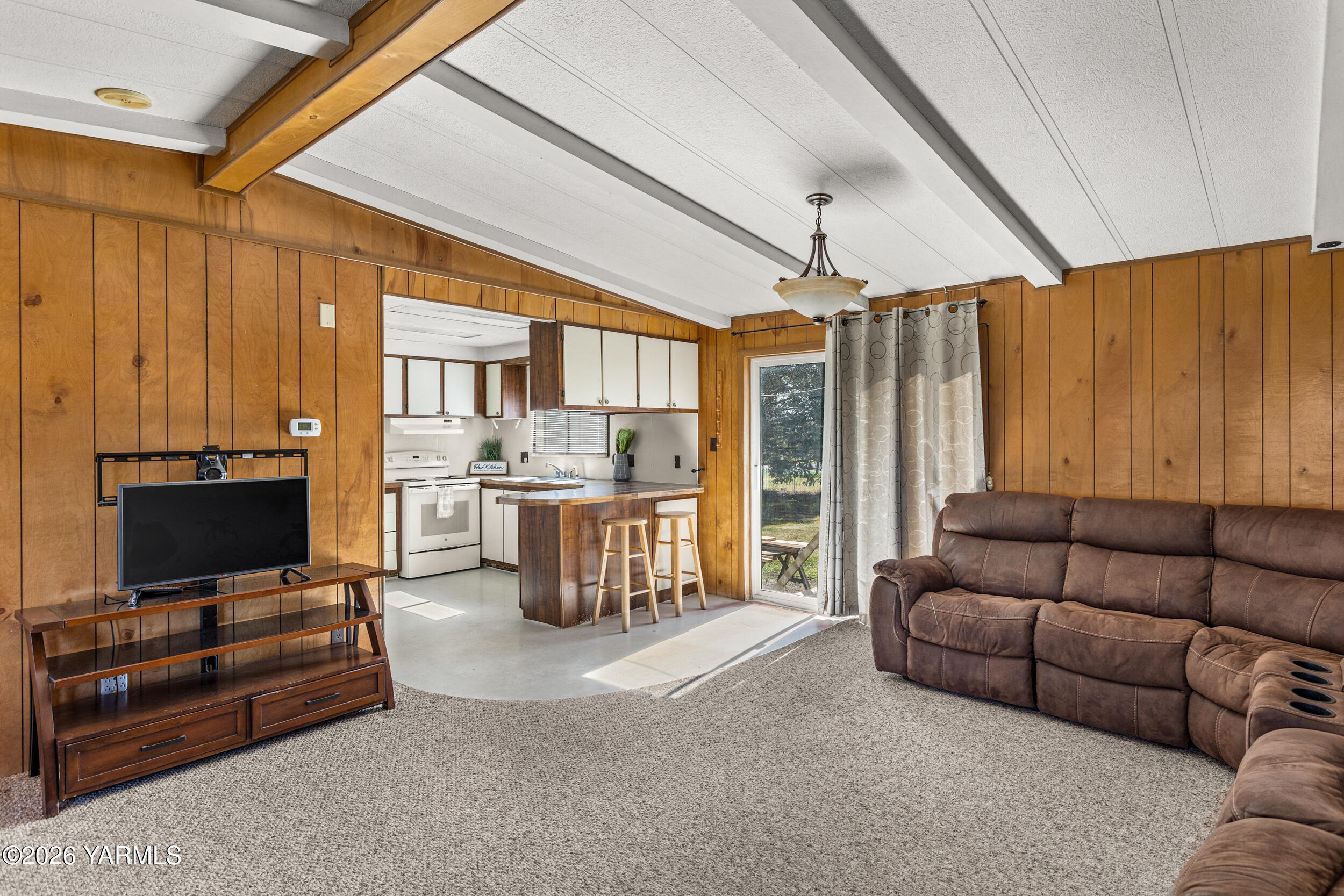 142 Foster Lane Selah, WA 98942 - Photo 7 of 21 a living room with furniture a flat screen tv and a window