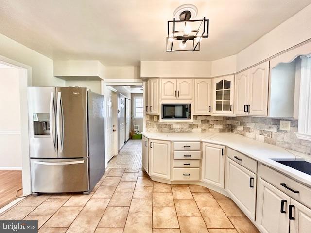 1409 Winding Waye Lane Silver Spring, MD 20902 - Photo 14 of 73 a kitchen with stainless steel appliances granite countertop a refrigerator and a stove top oven