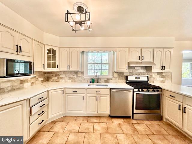 1409 Winding Waye Lane Silver Spring, MD 20902 - Photo 15 of 73 a kitchen with stainless steel appliances granite countertop a stove a sink and a microwave