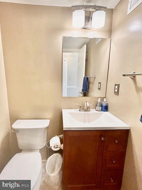 1409 Winding Waye Lane Silver Spring, MD 20902 - Photo 27 of 73 a bathroom with a toilet sink and mirror
