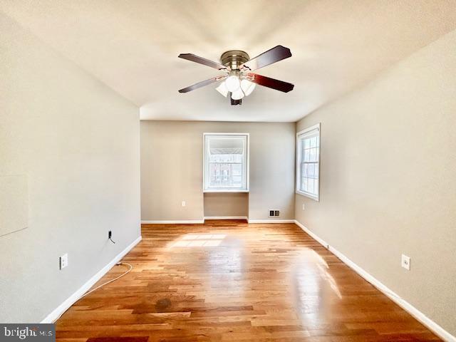 1409 Winding Waye Lane Silver Spring, MD 20902 - Photo 30 of 73 a view of an empty room with window and chandelier fan