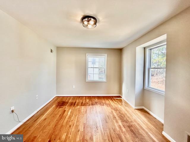 1409 Winding Waye Lane Silver Spring, MD 20902 - Photo 38 of 73 a view of a room with wooden floor and windows