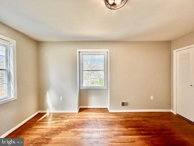 1409 Winding Waye Lane Silver Spring, MD 20902 - Photo 39 of 73 a view of an empty room with window and wooden floor
