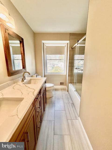 1409 Winding Waye Lane Silver Spring, MD 20902 - Photo 42 of 73 a bathroom with a granite countertop sink a large mirror and a bathtub