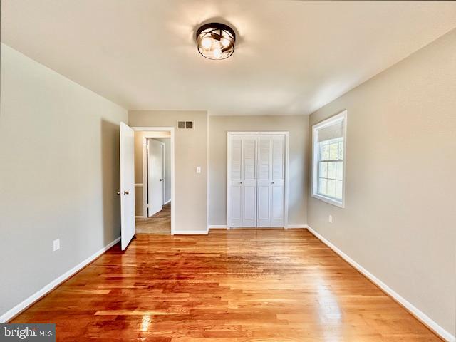 1409 Winding Waye Lane Silver Spring, MD 20902 - Photo 50 of 73 a view of an empty room with window and wooden floor