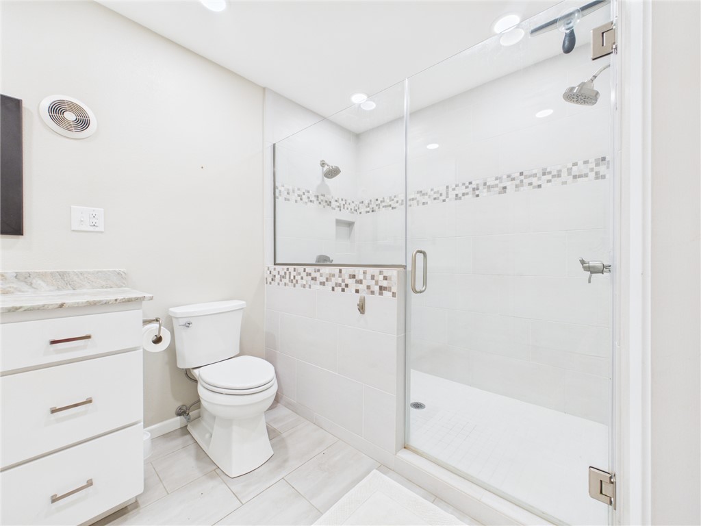 902 Briar Bend Court Bryan, TX 77802 - Photo 17 of 39 a bathroom with a granite countertop sink a toilet and shower