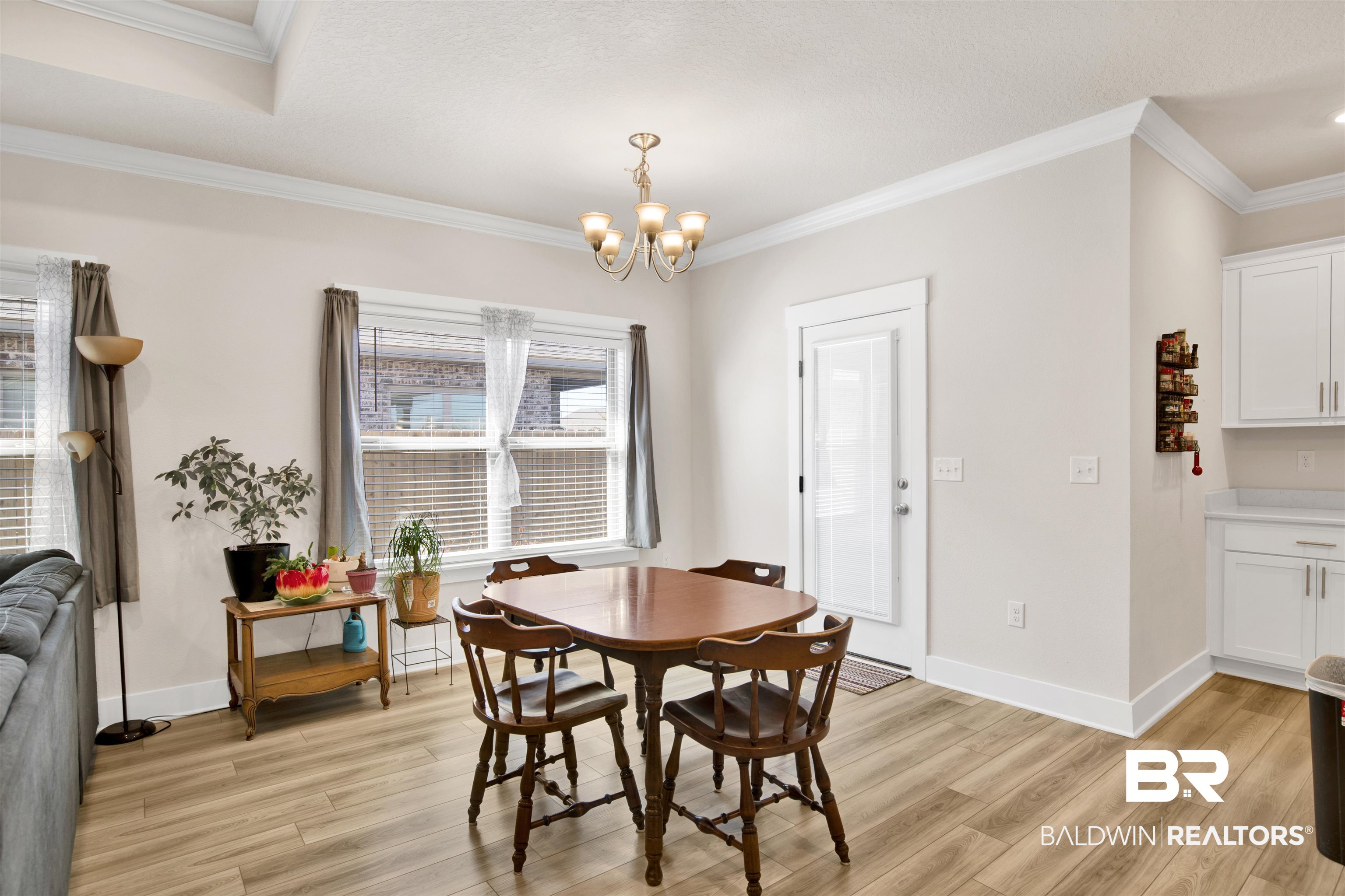 1174 Pheasant Circle Foley, AL 36535 - Photo 10 of 29 Dining room featuring ornamental molding, light wood-style flooring, and a chandelier