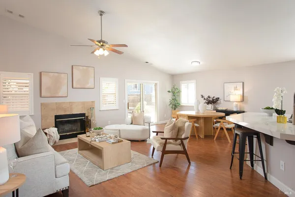 a living room with furniture a fireplace and a window