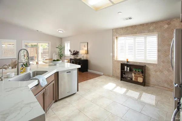 a large kitchen with a table and chairs in it