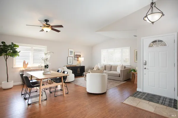 a view of a livingroom with furniture window and wooden floor