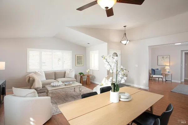 a living room with furniture a chandelier and a table