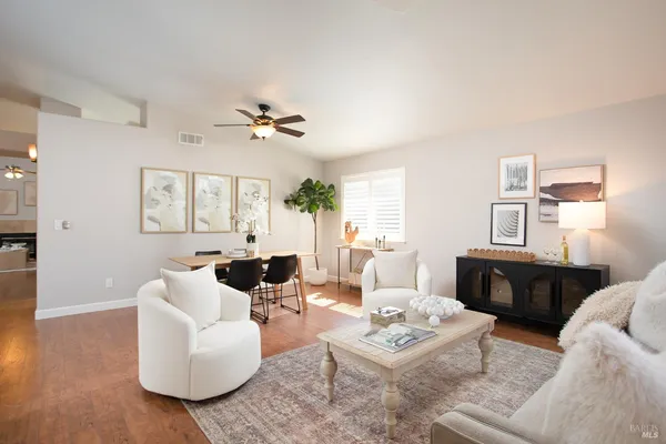 a living room with furniture a table and a window
