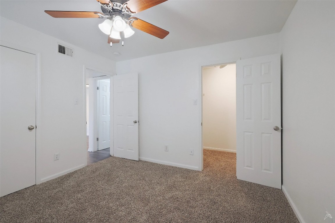 2323 Wells Branch Parkway, Unit A205 Austin, TX 78728 - Photo 11 of 22 an empty room with closet and a chandelier fan
