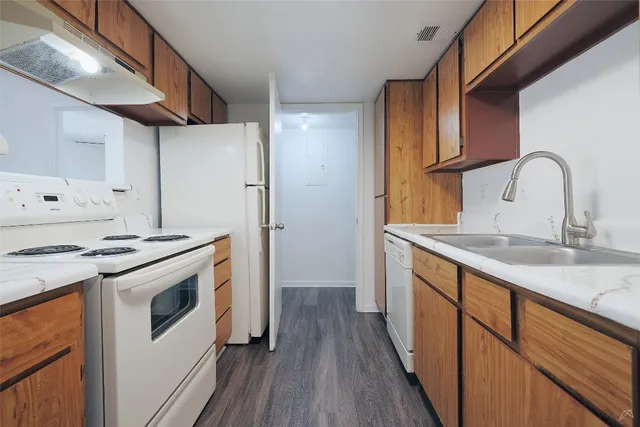 a kitchen with stainless steel appliances granite countertop a stove and a refrigerator