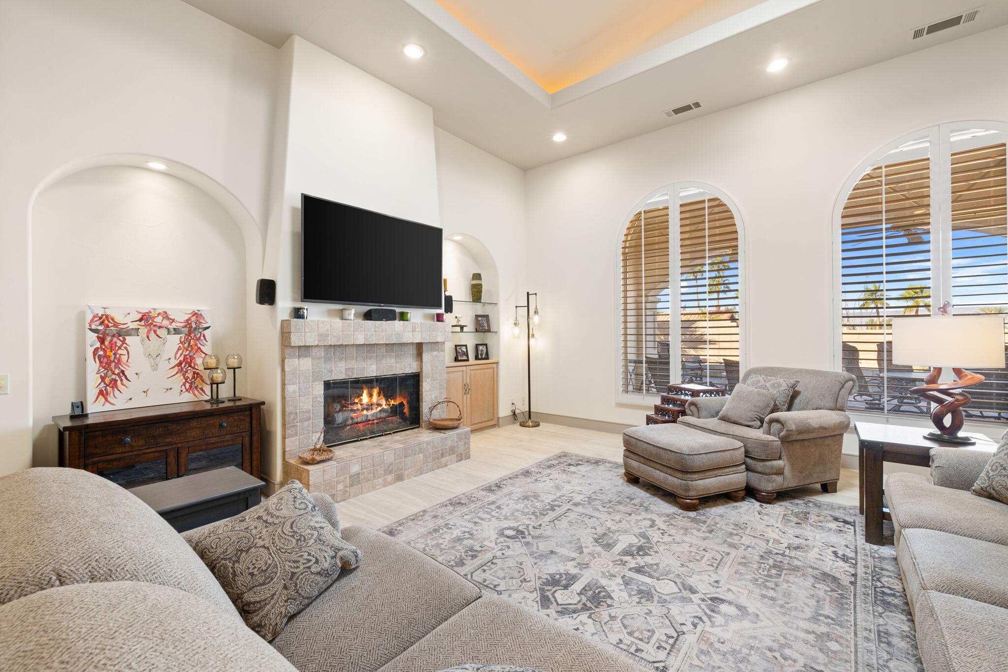 73110 Calliandra Street Palm Desert, CA 92260 - Photo 11 of 67 a living room with furniture a fireplace and a flat screen tv