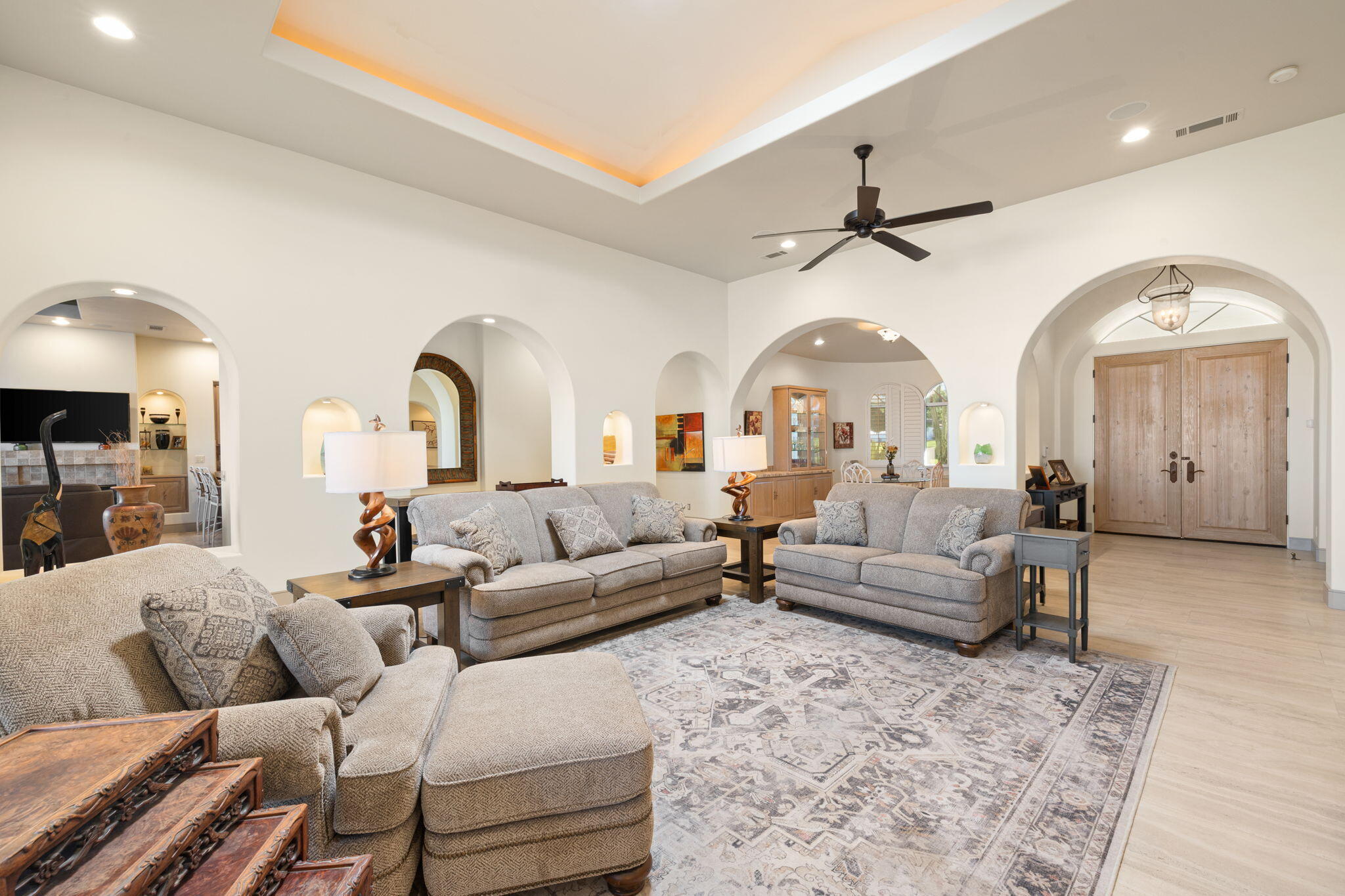 73110 Calliandra Street Palm Desert, CA 92260 - Photo 13 of 67 a living room with furniture a large window and a chandelier