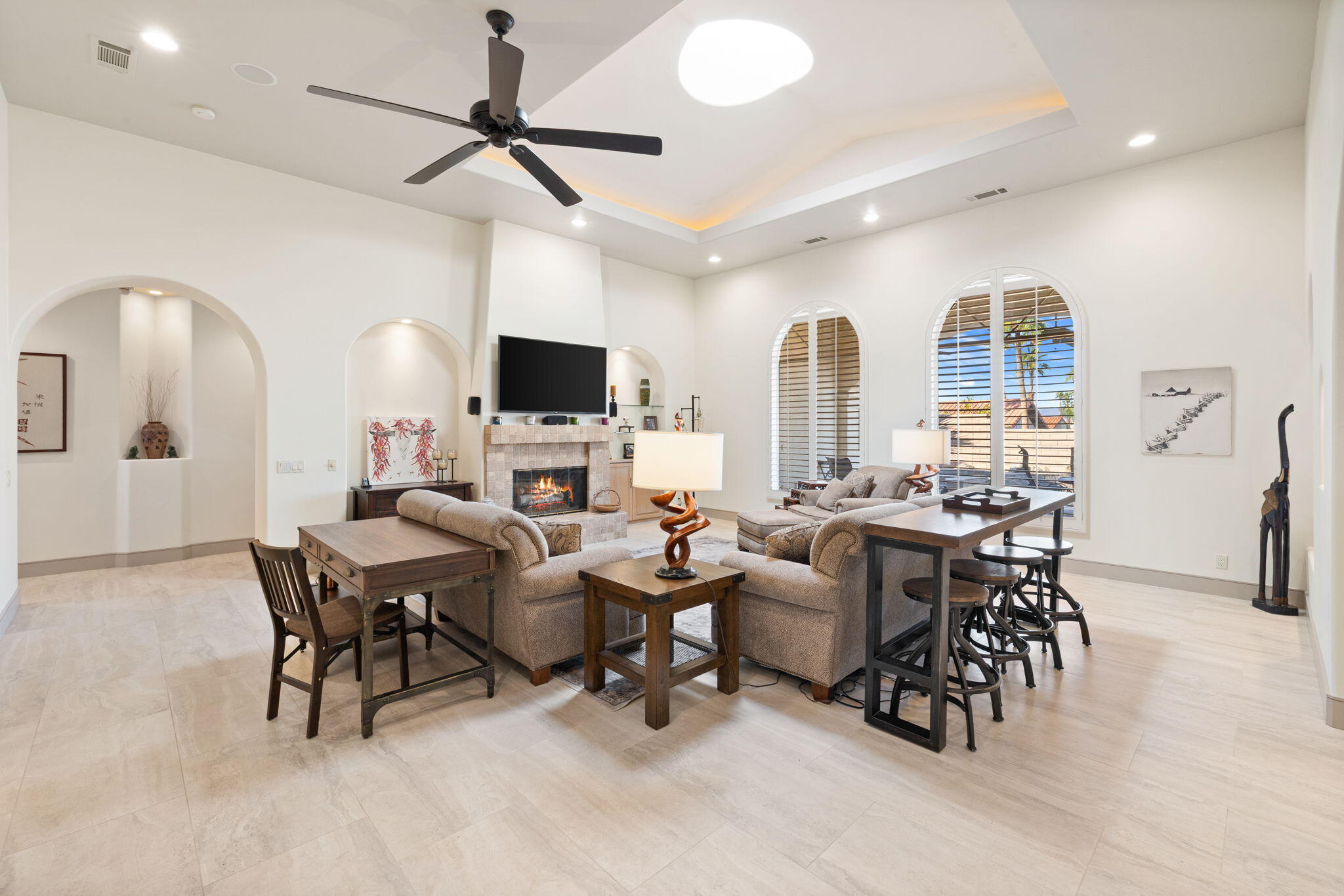 73110 Calliandra Street Palm Desert, CA 92260 - Photo 14 of 67 a living room with furniture a fireplace and a flat screen tv