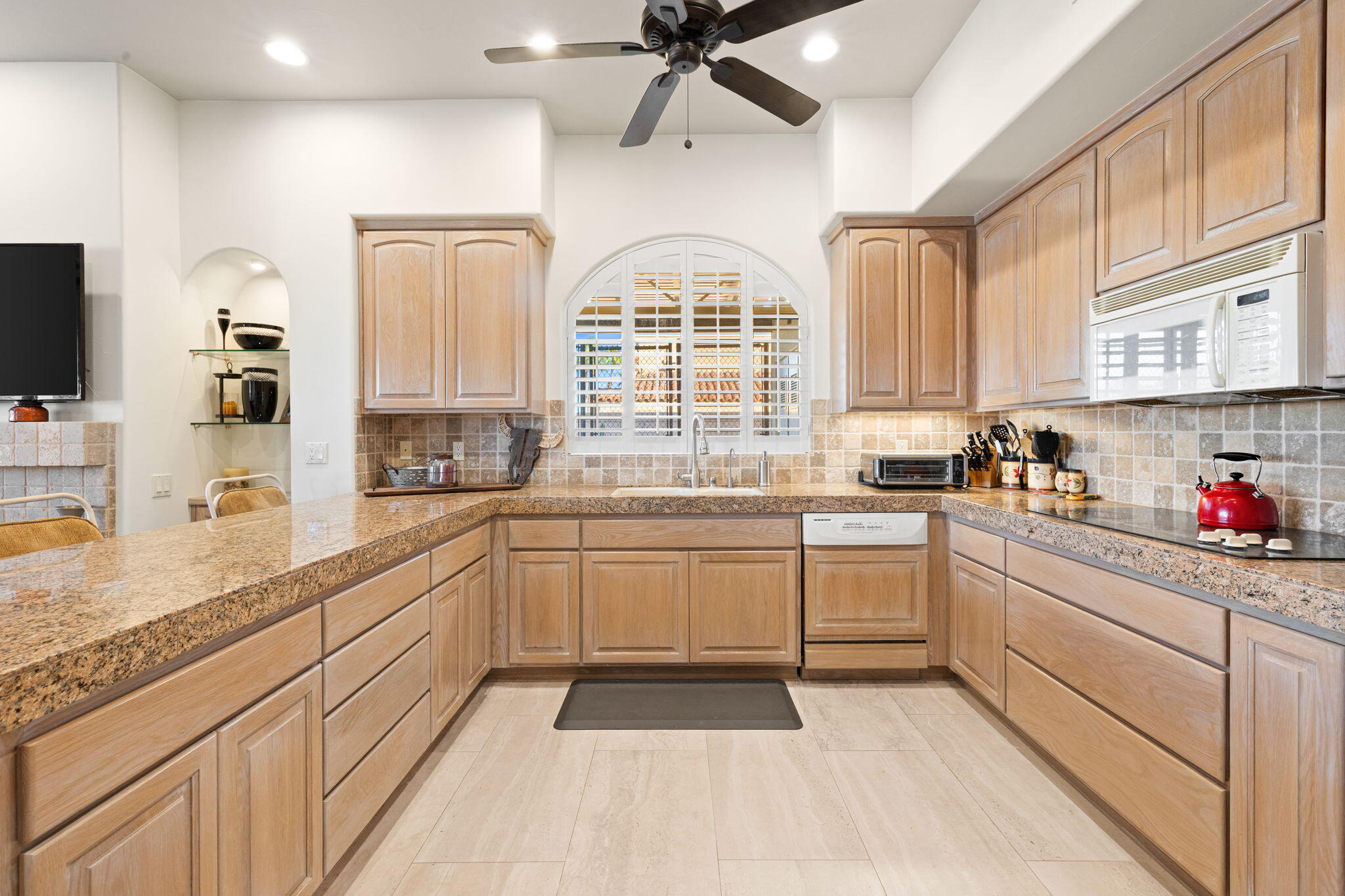 73110 Calliandra Street Palm Desert, CA 92260 - Photo 18 of 67 a kitchen with granite countertop a sink stainless steel appliances and cabinets