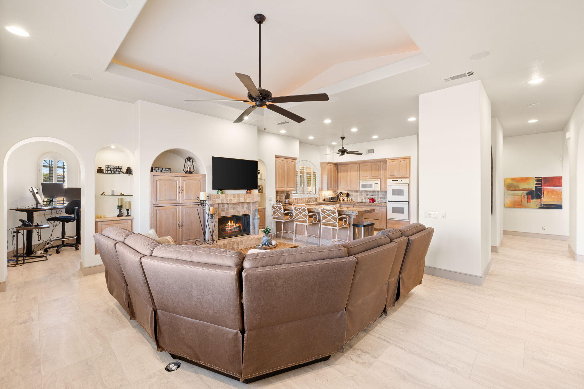 73110 Calliandra Street Palm Desert, CA 92260 - Photo 23 of 67 a living room with furniture a flat screen tv and kitchen view