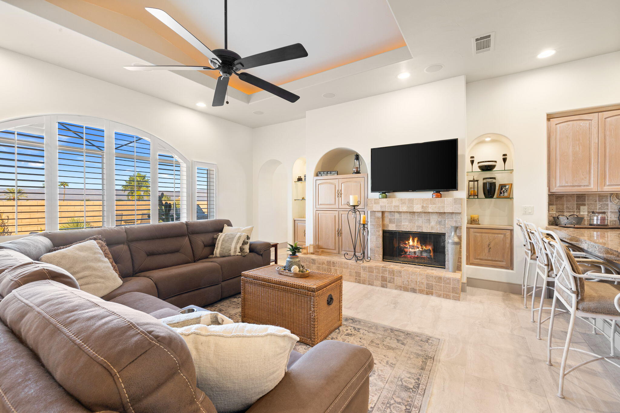 73110 Calliandra Street Palm Desert, CA 92260 - Photo 26 of 67 a living room with furniture a fireplace and a flat screen tv