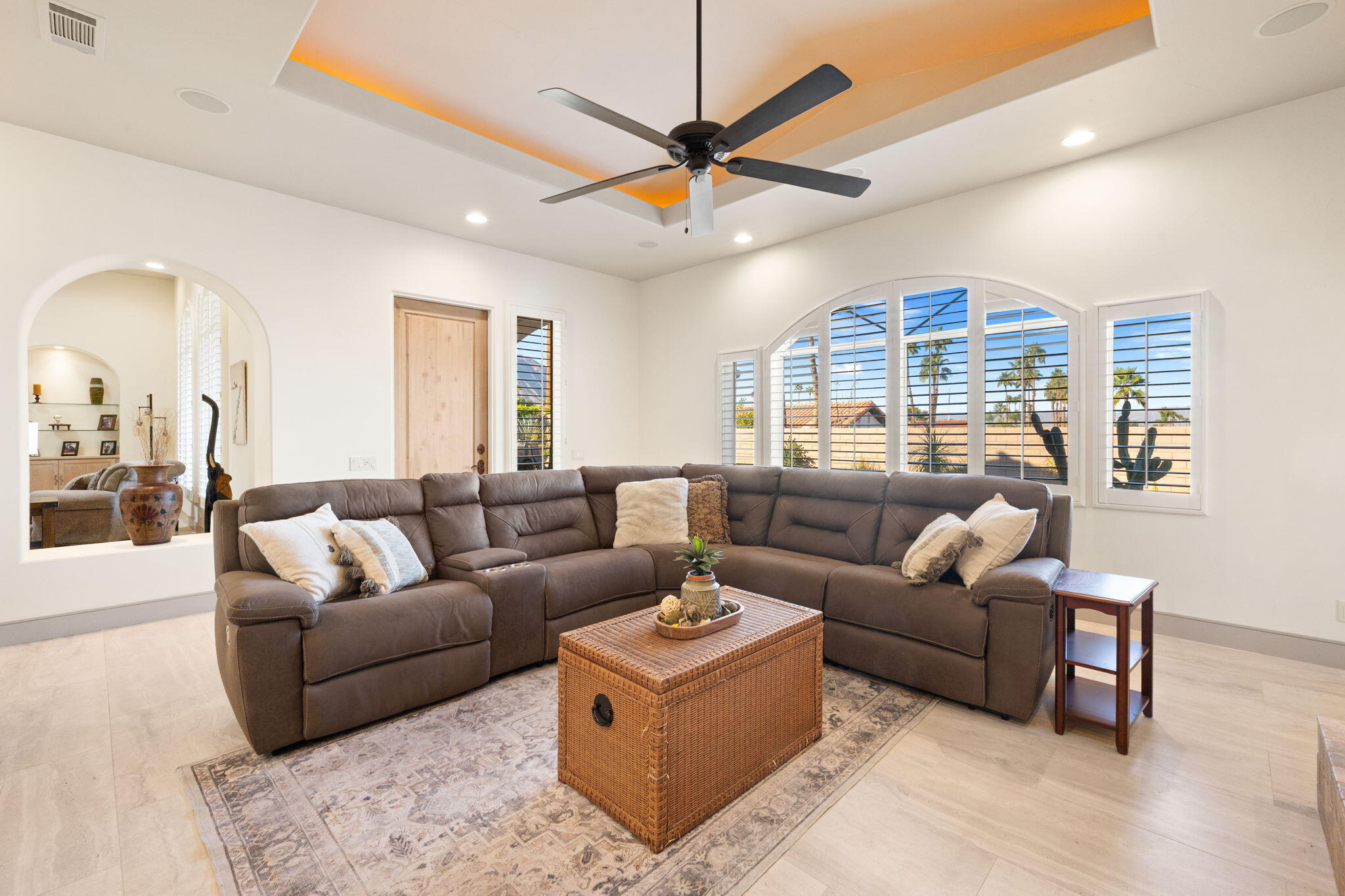 73110 Calliandra Street Palm Desert, CA 92260 - Photo 27 of 67 a living room with furniture a ceiling fan and a large window