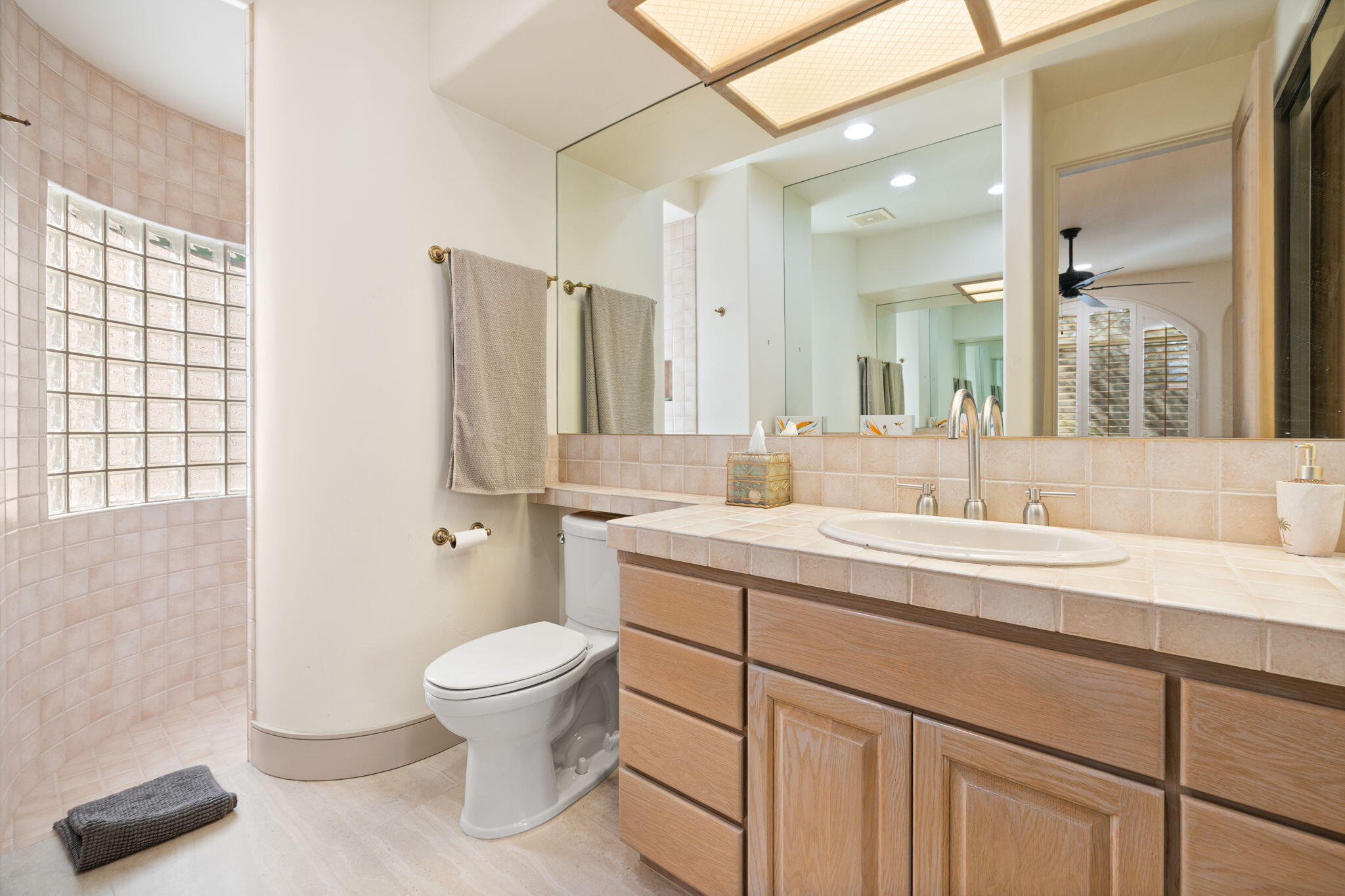 73110 Calliandra Street Palm Desert, CA 92260 - Photo 33 of 67 a spacious bathroom with a double vanity sink toilet and a mirror